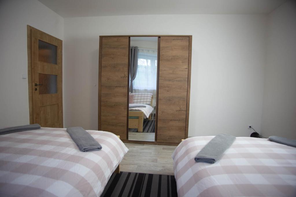 Postel nebo postele na pokoji v ubytování Apartmány Ve Mlejně