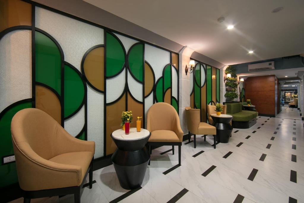 a waiting room with chairs and a wall with plants at Hanoi La Selva Central Hotel & Spa in Hanoi