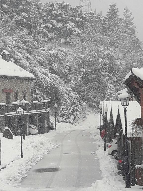 a snow covered street with cars parked on the side at Unifamiliar con jardin VU-HUESCA-22-315 in Villanúa