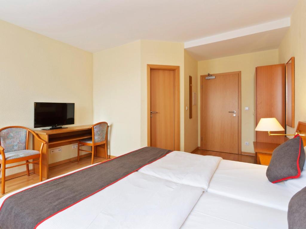 Postel nebo postele na pokoji v ubytování Hotel Bohemia