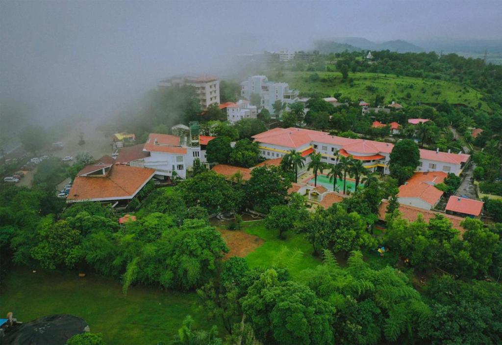 an aerial view of a town in a forest at Manas Lifestyle Resort, Igatpuri in Igatpuri