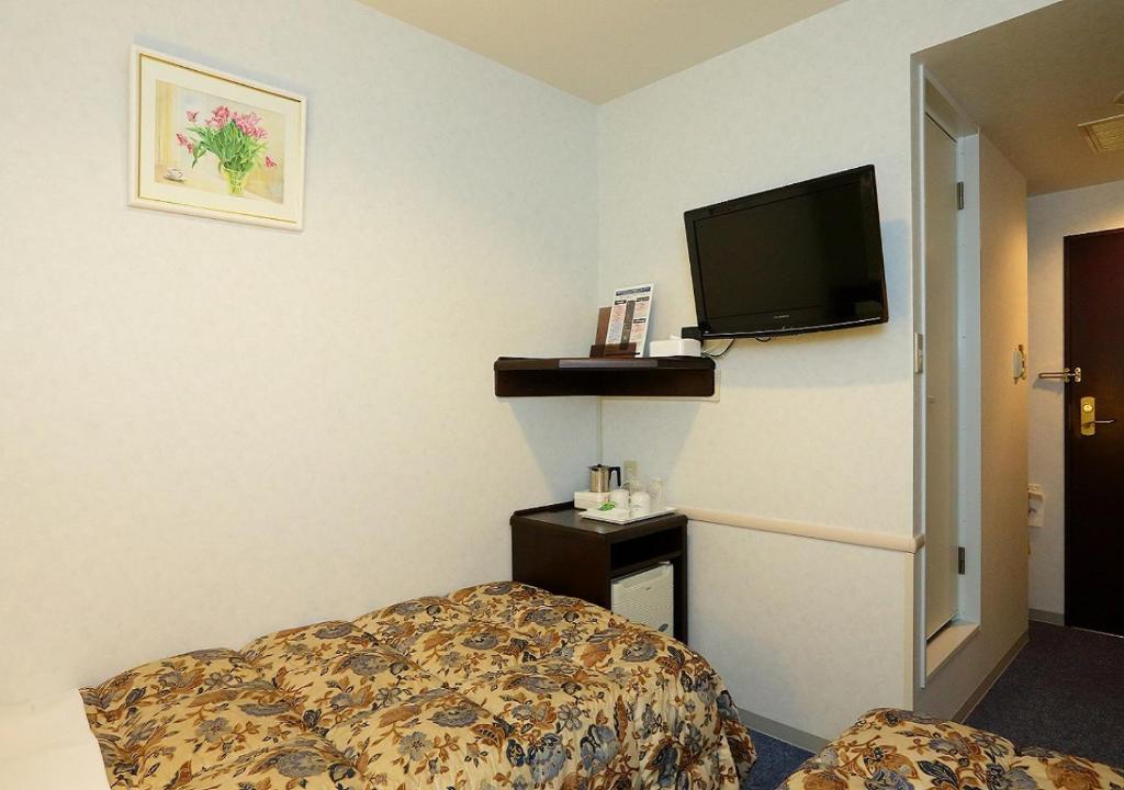 Postel nebo postele na pokoji v ubytování Hamamatsu Hotel