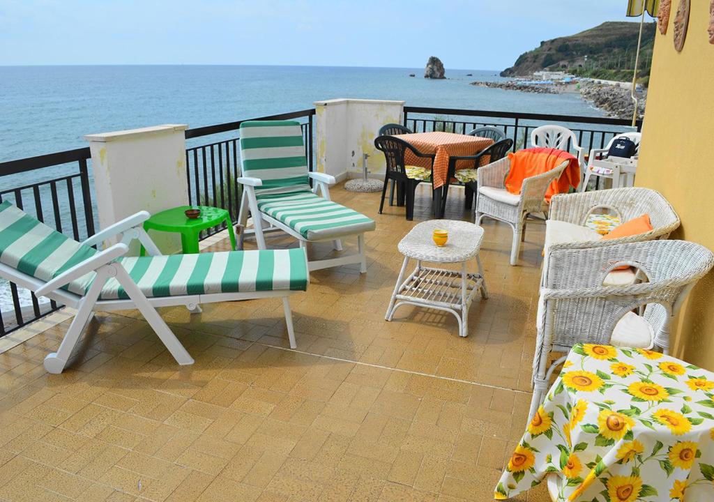 a balcony with chairs and a table and the ocean at Villa Irma sul mare in Marina