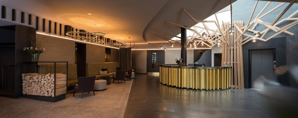 a lobby with a reception desk in a building at Parkhotel Schmid in Adelsried