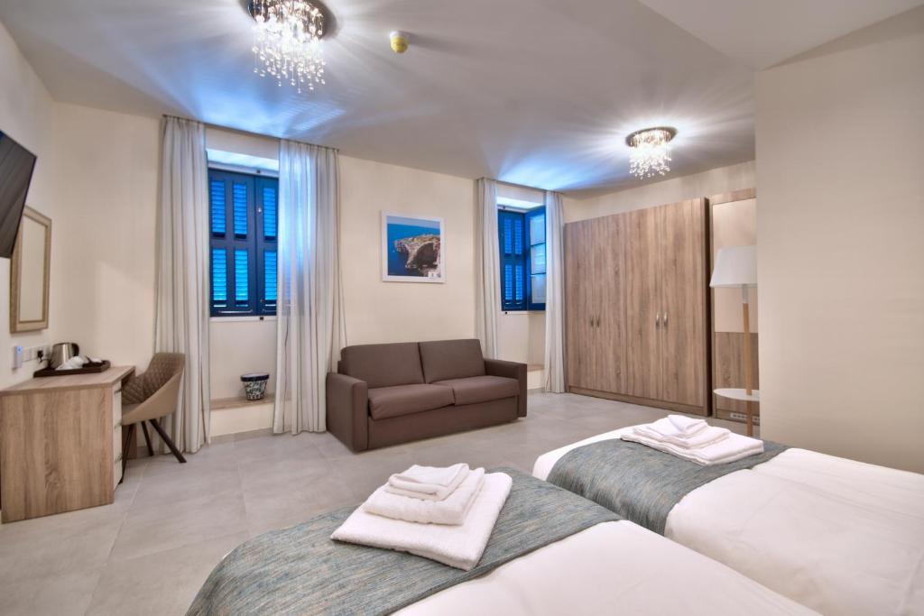 Postel nebo postele na pokoji v ubytování The Suites – Piazza Kirkop