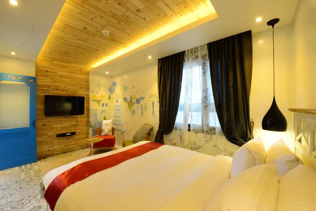 Postel nebo postele na pokoji v ubytování Dunsan Graytone Hotel