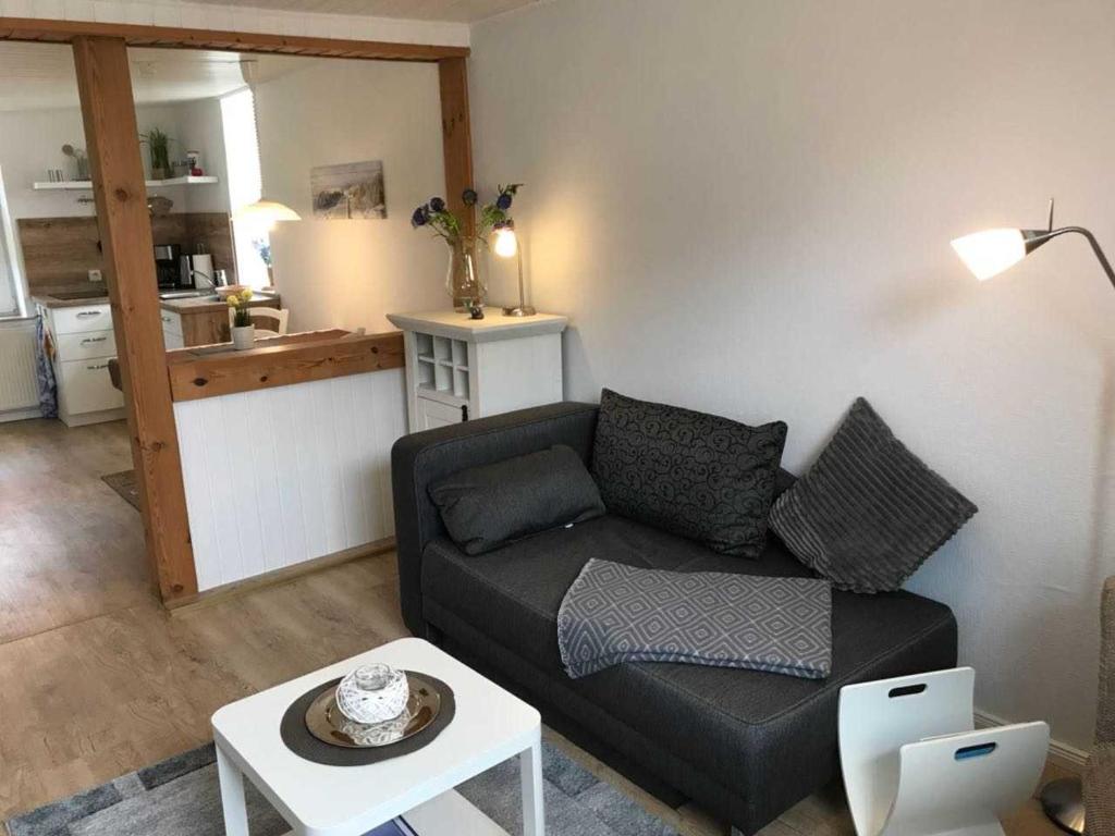 a living room with a couch and a table at Haegerende _Alte Liebe_ in Groß Kirr