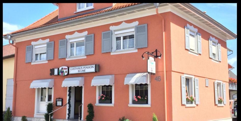 a large orange building with a sign in front of it at Gasthaus&Pension Blume Ötigheim in Ötigheim