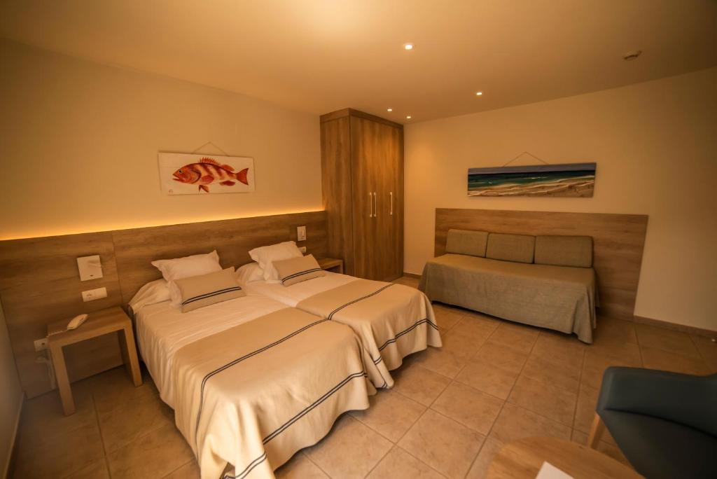 Postel nebo postele na pokoji v ubytování Hotel Tamariu
