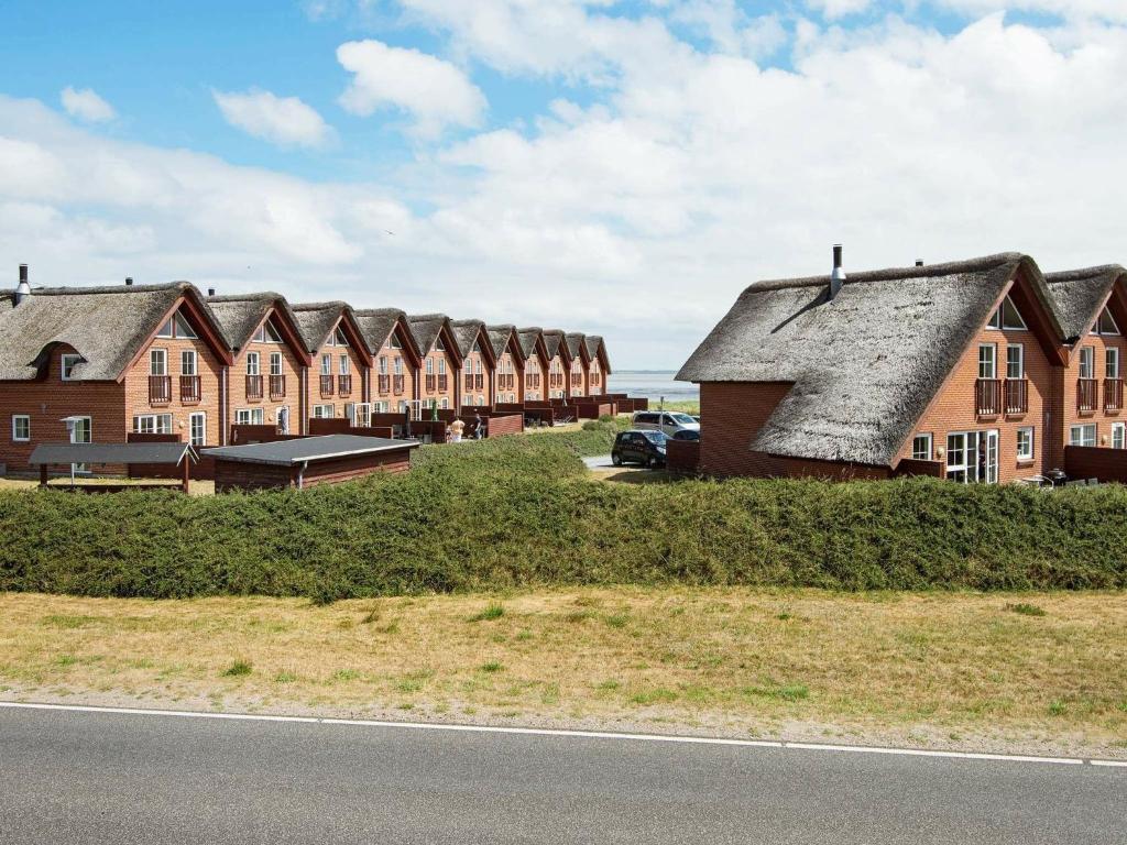 a row of houses on the side of a road at Three-Bedroom Holiday home in Rømø 5 in Kongsmark
