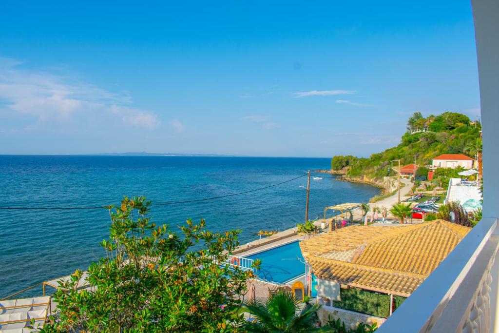 a view of the ocean from a balcony at Agoulos Beach Hotel in Argasi