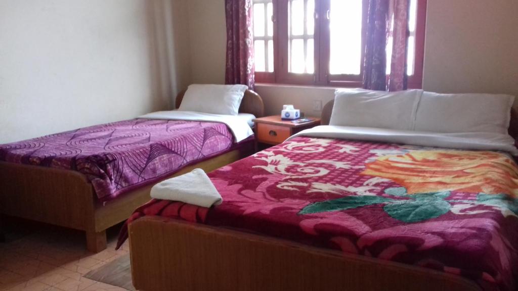 Postel nebo postele na pokoji v ubytování Sunset guest house