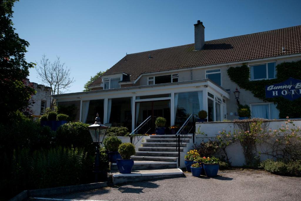 a house with a staircase in front of it at Sunny Brae Bed & Breakfast in Nairn