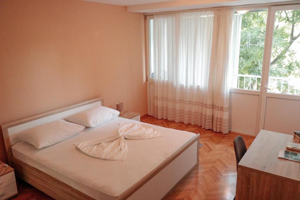 a bedroom with a white bed with a window at Apartment Dream of Split in Split