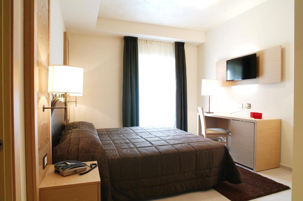 Postel nebo postele na pokoji v ubytování Hotel Duchessa Della Sila