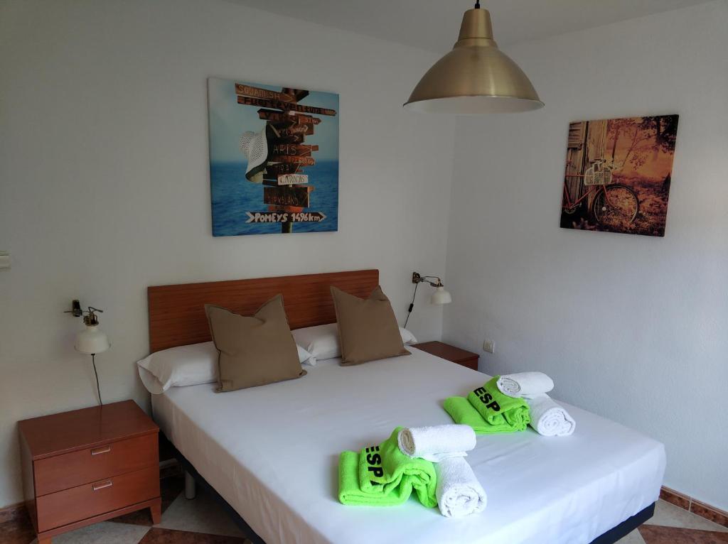 a bedroom with a bed with green shoes on it at CASA CARMEN 20 in Málaga