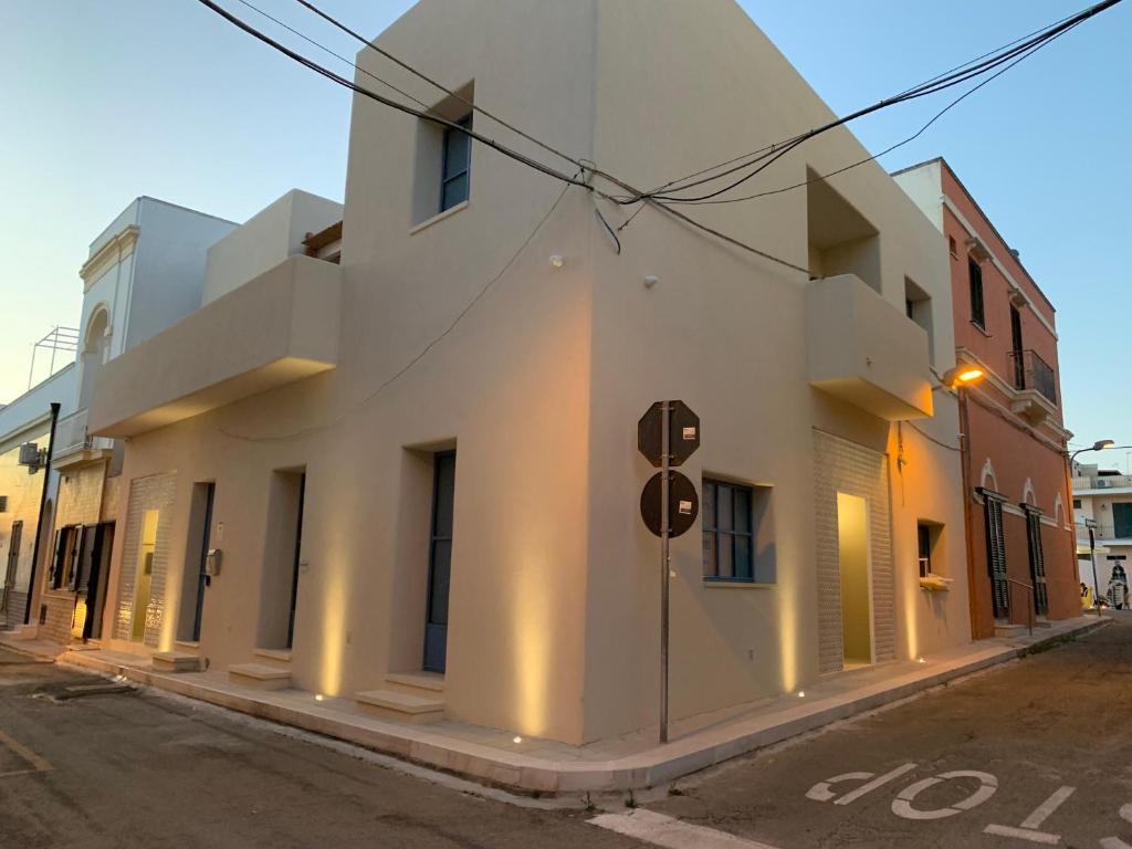 een wit gebouw aan de straatkant bij La Naca sul Mare - Suite in Nardò