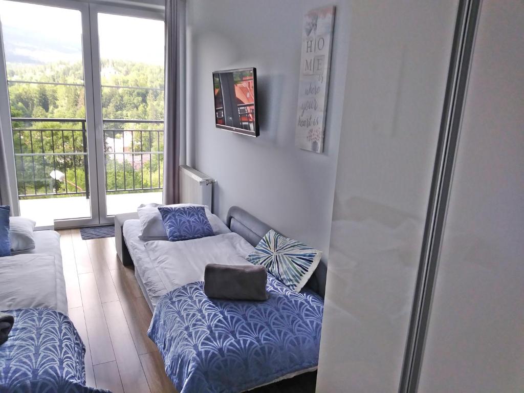 Postel nebo postele na pokoji v ubytování Apartamenty Amika