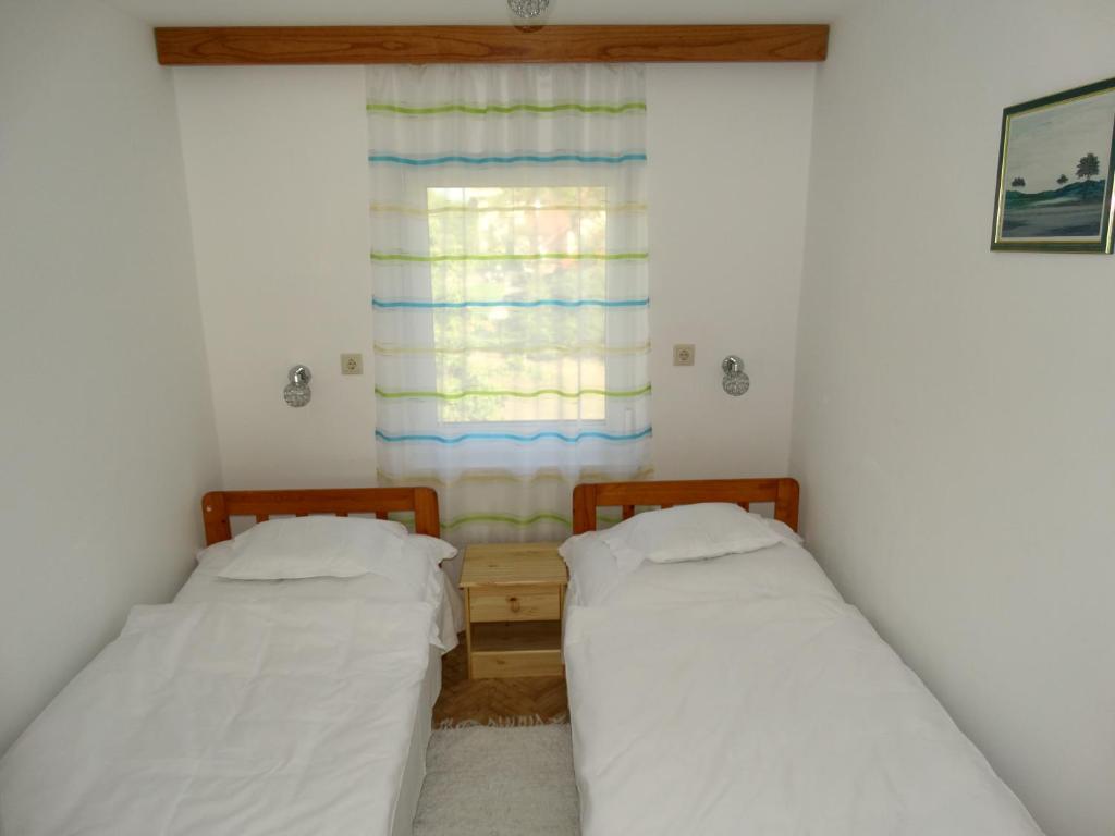 A bed or beds in a room at Tulipán Vendégház