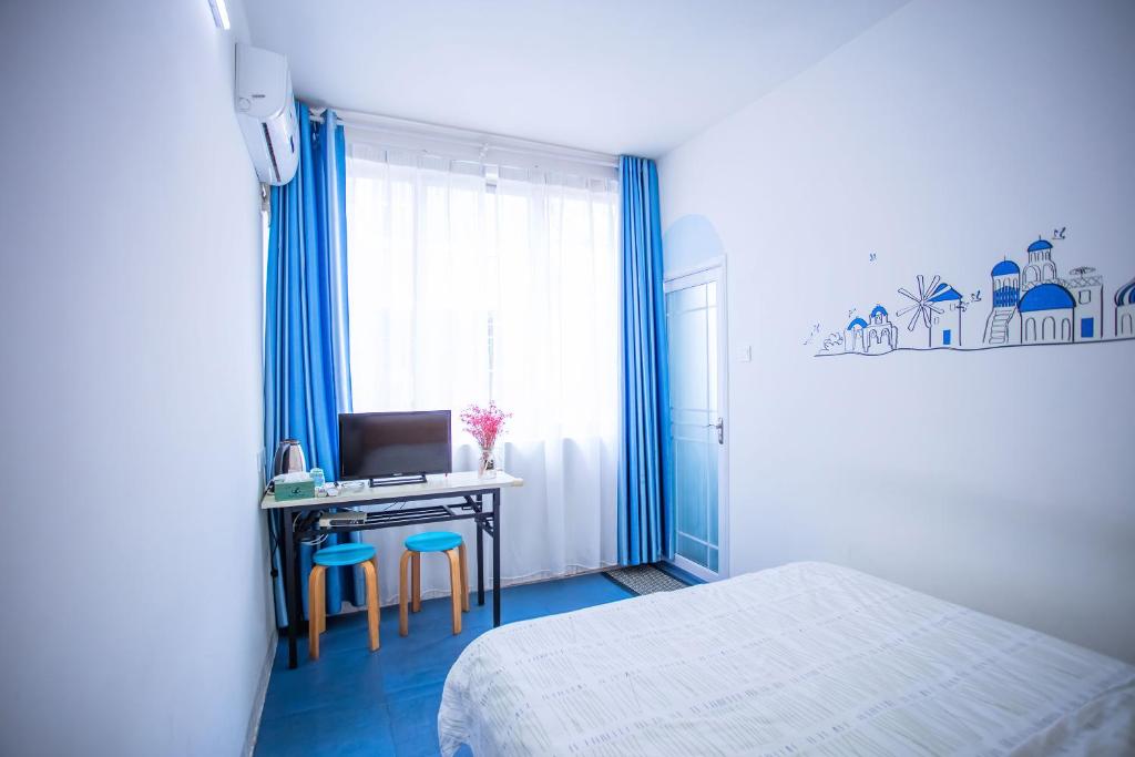 Postel nebo postele na pokoji v ubytování Murphy Youth Hostel Guilin桂林北站莫非青年旅舍