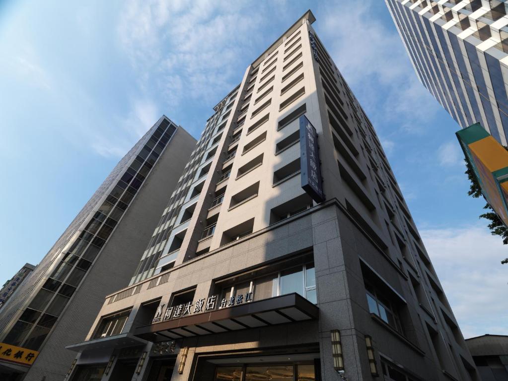 a tall building with a sign on it at K Hotel Taipei Songjiang in Taipei