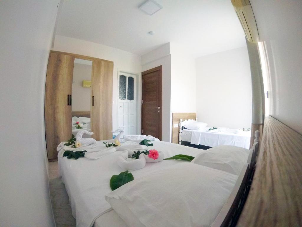 Postel nebo postele na pokoji v ubytování Kaizen Gate Hotel