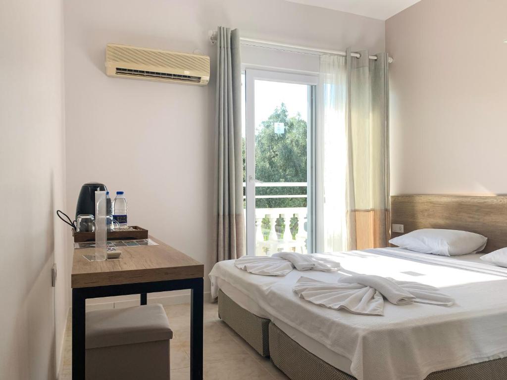 Postel nebo postele na pokoji v ubytování Kaizen Gate Hotel