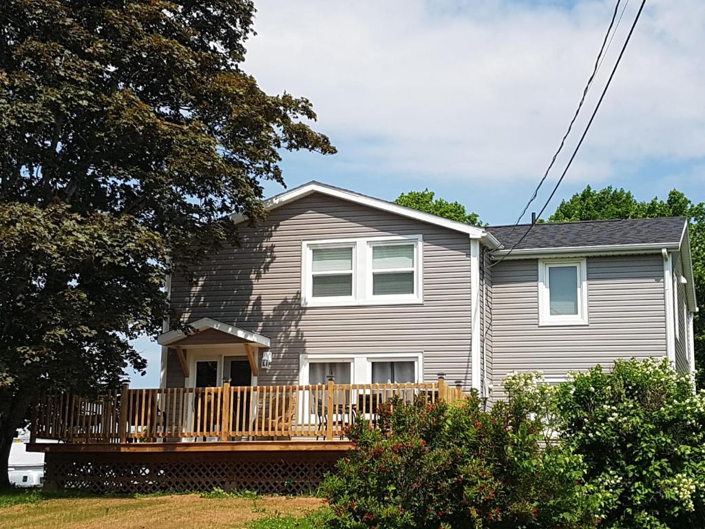 a house with a porch and a deck at Small Town Bound Inn in Montague