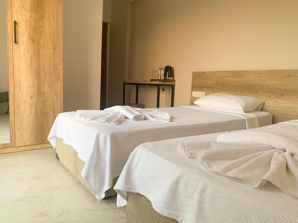 Postel nebo postele na pokoji v ubytování Kaizen Gate Hotel