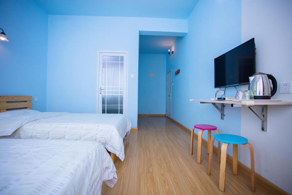 Postel nebo postele na pokoji v ubytování Murphy Youth Hostel Guilin桂林北站莫非青年旅舍