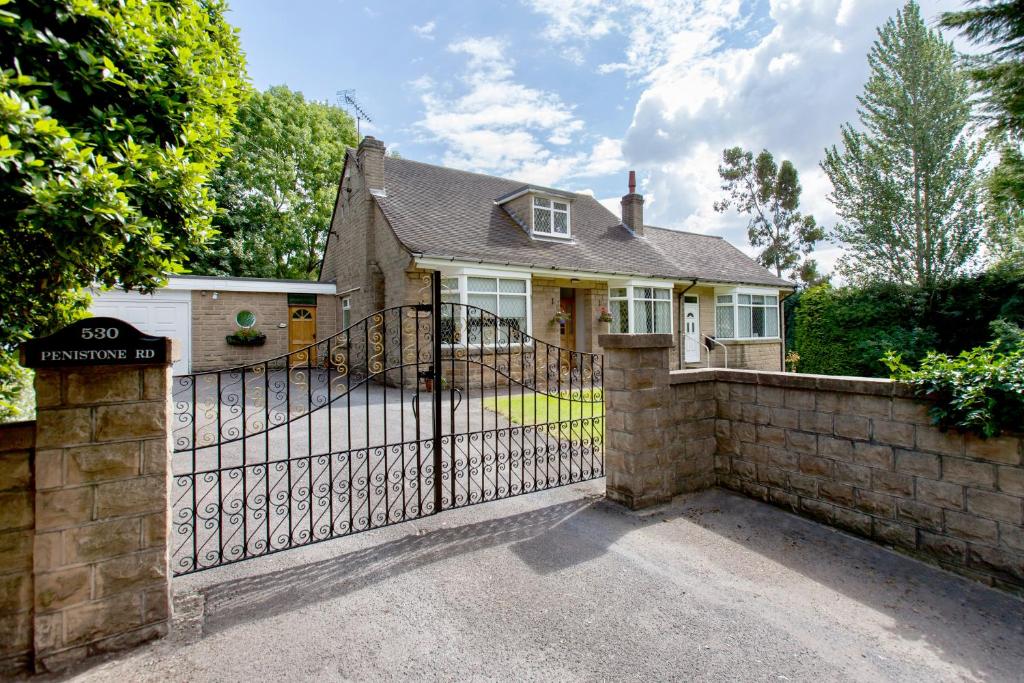 a house with a wrought iron gate and a driveway at Fernbank Suite in Sheffield