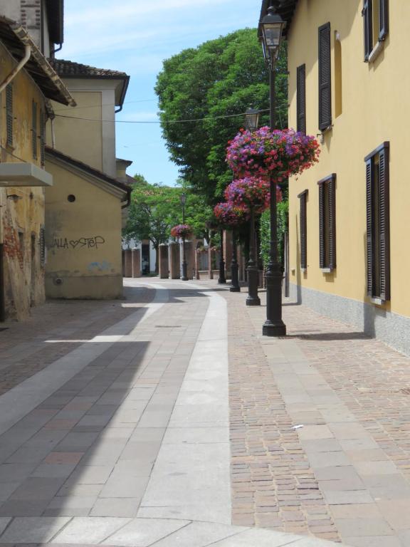 an empty street in a town with flowers on a pole at Assago Forum 12 in Assago