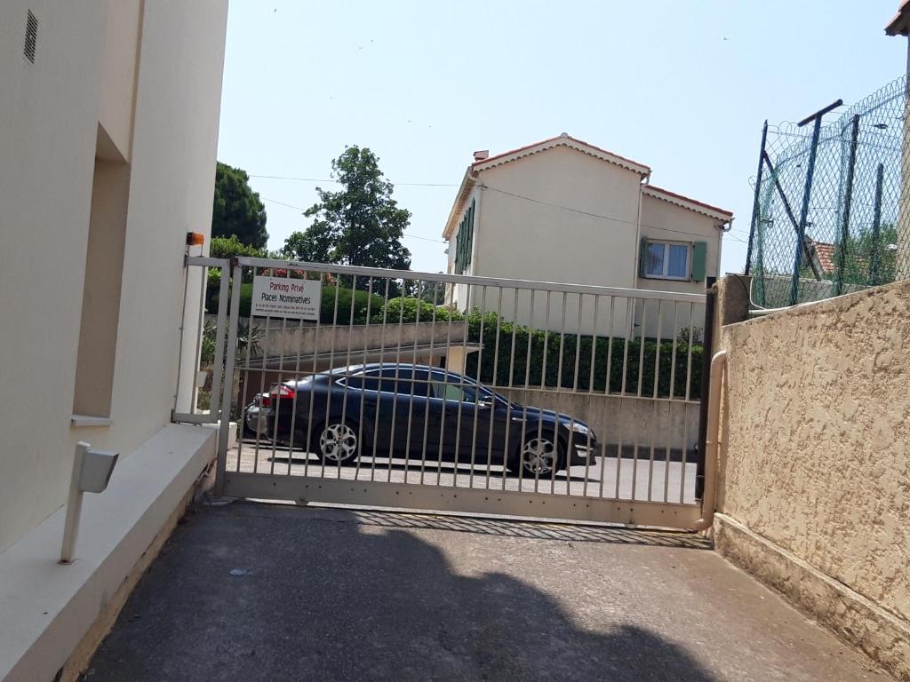 a car parked behind a gate in a driveway at Antibes: A nest perched on the sea! in Antibes