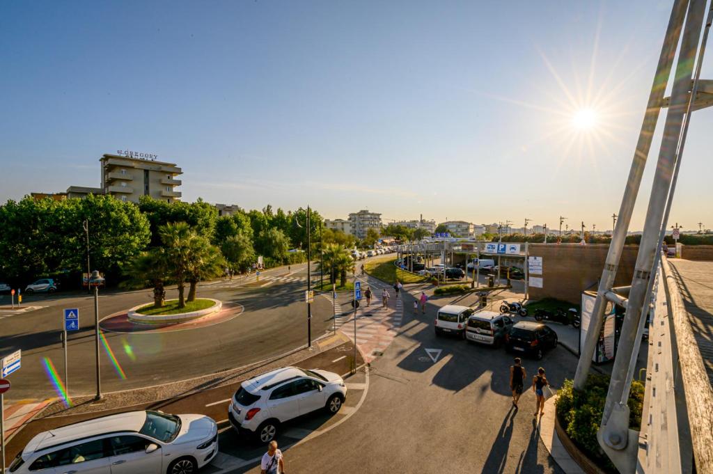 a street with cars parked in a parking lot at Hotel St Gregory Park in Rimini