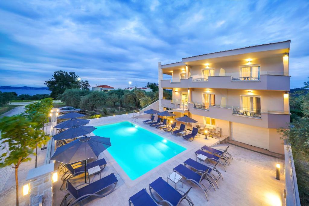 an aerial view of a hotel with a swimming pool at Iliomagic Luxury Suites Thassos in Limenas