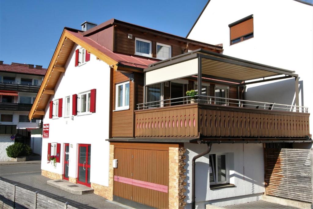 una casa con un balcón en el lateral. en Alpenflair Ferienwohnungen "Haus Doris", en Oberstdorf