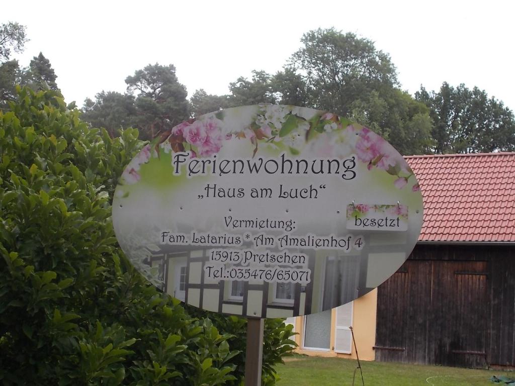 a sign with flowers on it in a yard at Haus am Luch in Markische Heide