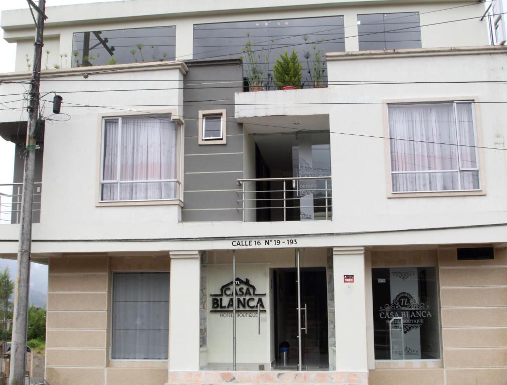 a building with a sign that reads city dance at TL Casa Blanca Hotel Boutique Sibundoy Putumayo in Sibundoy