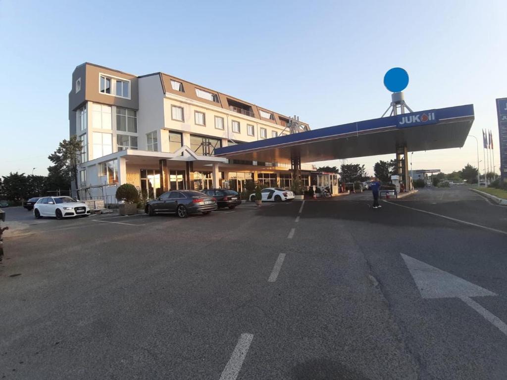 a gas station with cars parked in a parking lot at Hotel LISS 2 in Lezhë