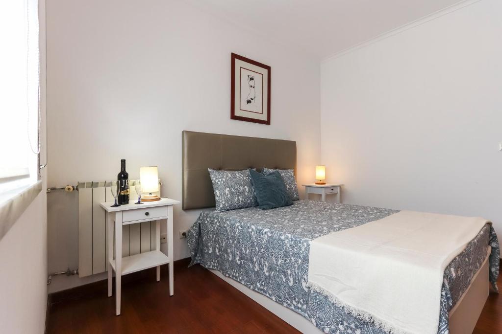 a bedroom with a bed and two night stands at Charming Guesthouse - Sónias Houses in Lisbon