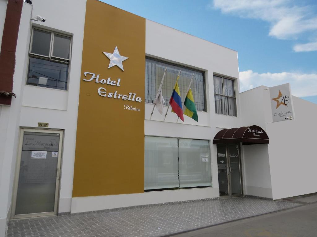 a building with a sign on the side of it at Hotel Estrella Palmira in Palmira