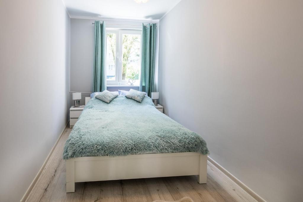 Posteľ alebo postele v izbe v ubytovaní Apartament uJasia