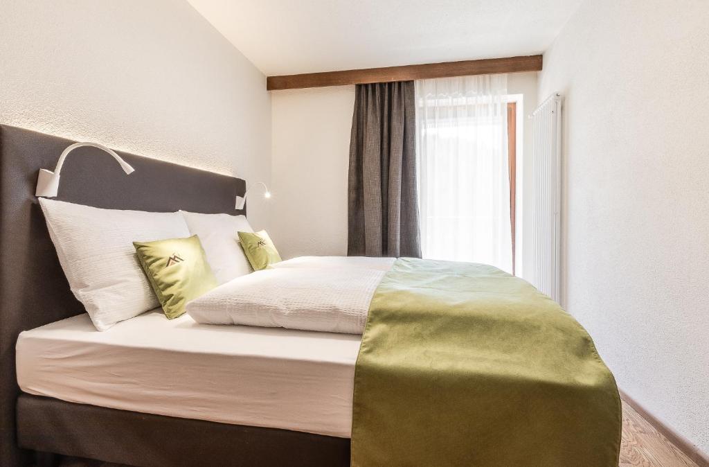 Posteľ alebo postele v izbe v ubytovaní Ciasa MAEL Dolomites Apartments