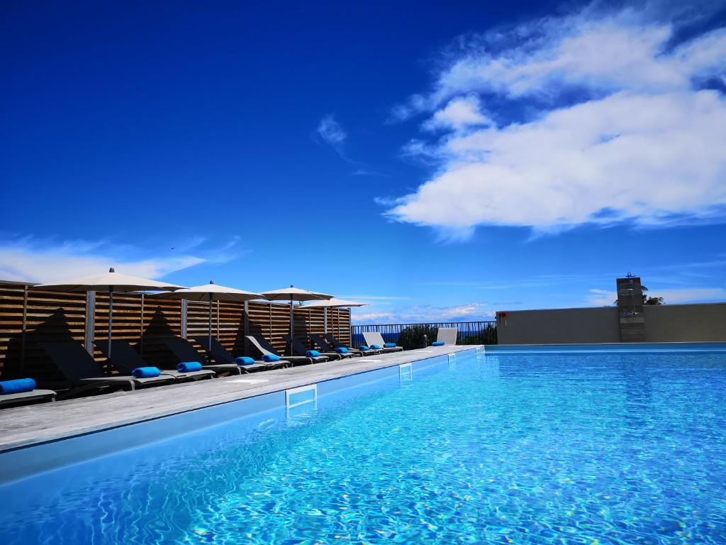 a swimming pool on the roof of a building at Hotel Residence Lido Marana in Furiani