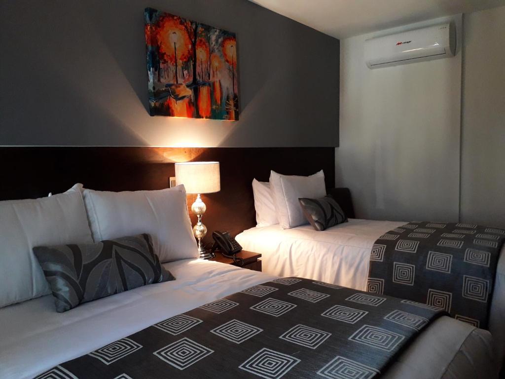 Postel nebo postele na pokoji v ubytování Hotel Corral Grande