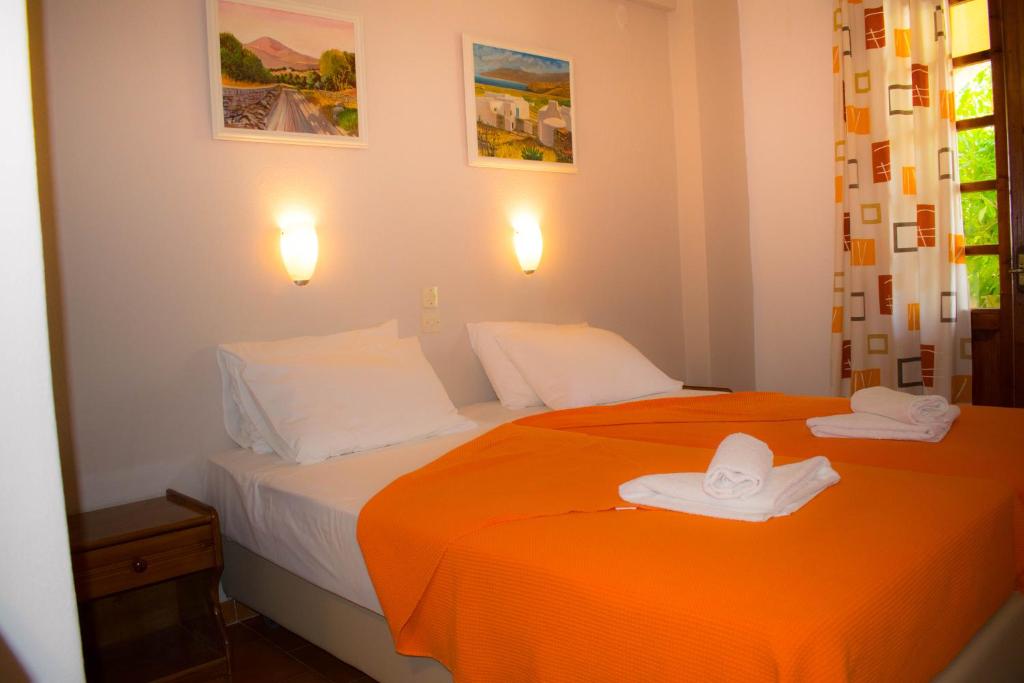 a bedroom with two beds with hats on them at Eleni's House Skiathos in Skiathos