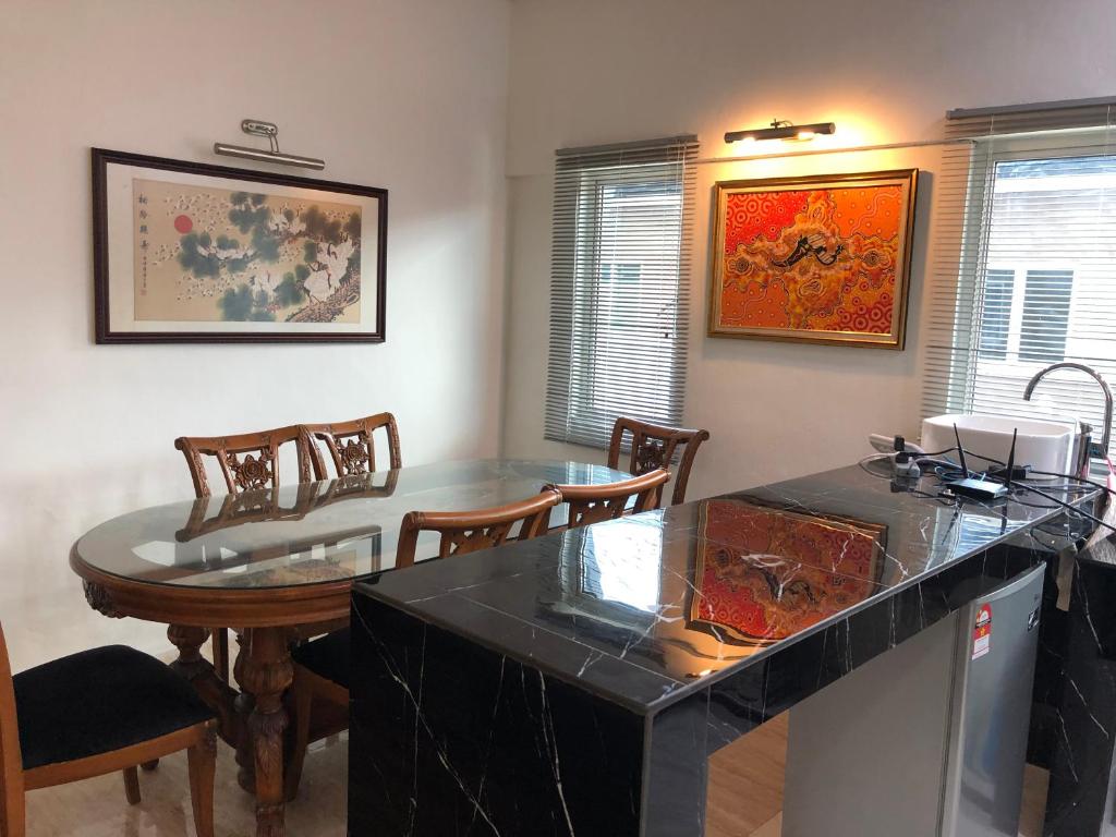 a kitchen with a table and chairs and a dining room at Home Suhaila in Kota Kinabalu