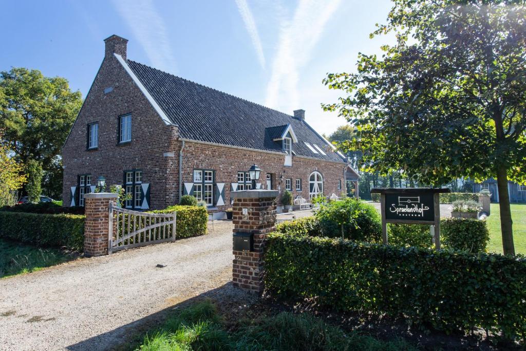 a brick church with a sign in front of it at Spraelandhof in Oostrum