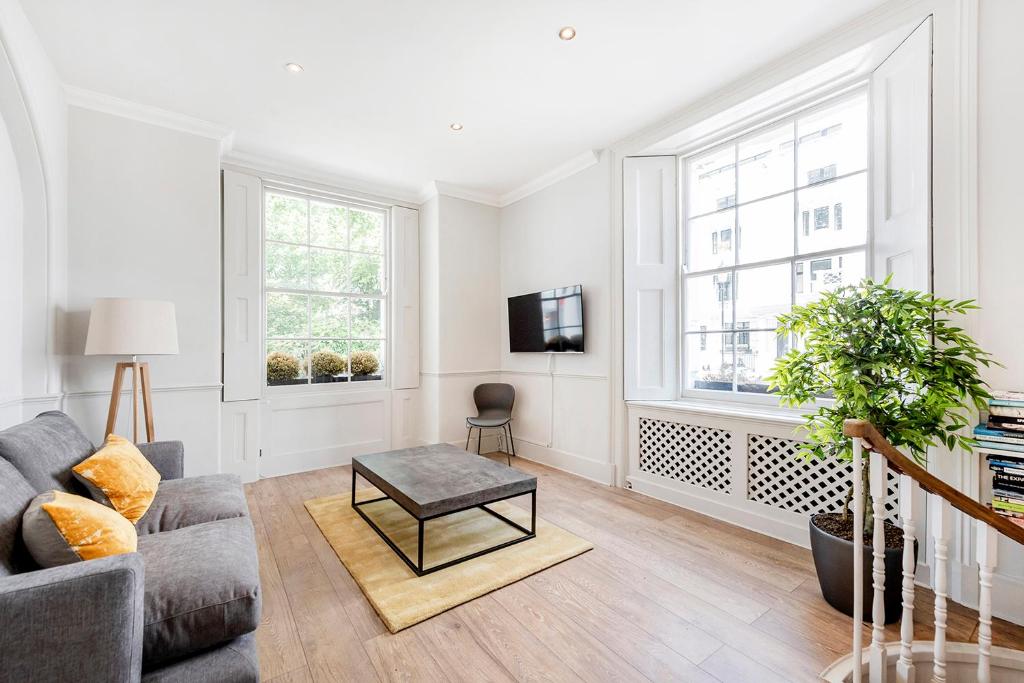 a living room with a couch and a table at Stylish 2 bedroom flat in Knightsbridge in London