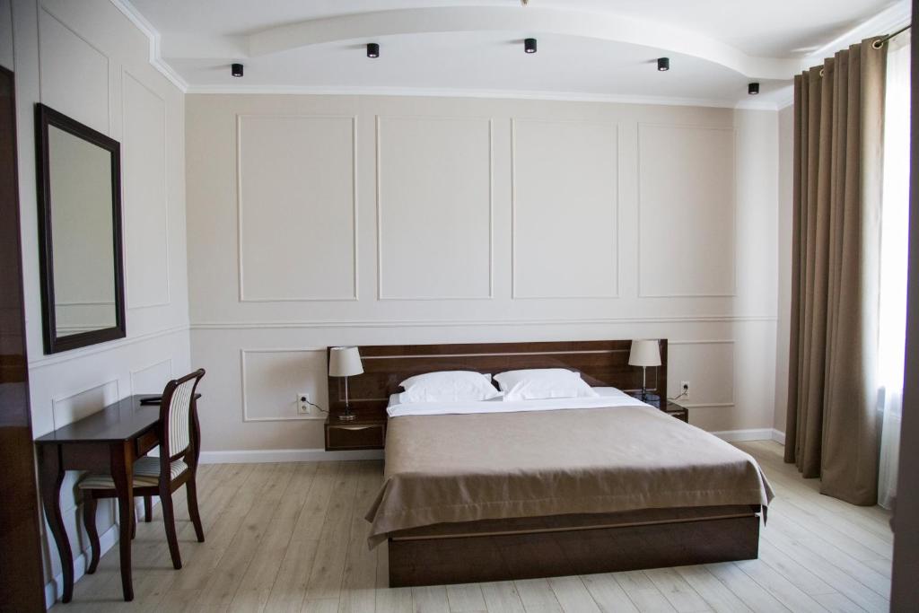 Postel nebo postele na pokoji v ubytování VIP Hotel